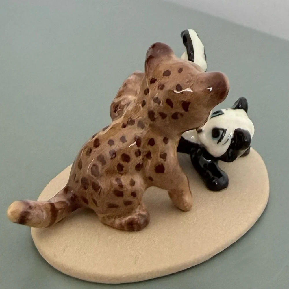 Vintage retired Hagen Renaker bobcat and skunk babies on base